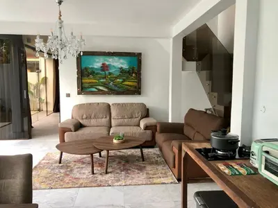 a living room with a couch and a table at Villa Denira in Nusa Dua