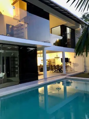 a house with a swimming pool in front of it at Villa Denira in Nusa Dua