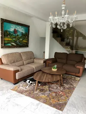 a living room with two couches and a coffee table at Villa Denira in Nusa Dua