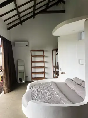 a bedroom with a large white bed in a room at Villa Denira in Nusa Dua