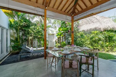 an outdoor dining area with a table and chairs at Villa Aniri - Seminyak Villa - Walk to Beach & Cafés in Seminyak