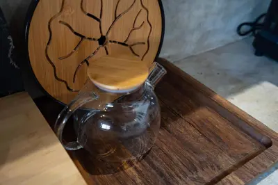 a glass vase sitting on top of a wooden table at Villa Aniri - Seminyak Villa - Walk to Beach & Cafés in Seminyak