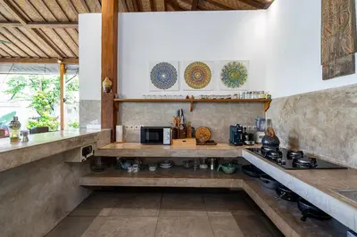 a kitchen with a stove and a counter top at Villa Aniri - Seminyak Villa - Walk to Beach & Cafés in Seminyak