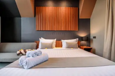 a bedroom with a large bed with towels on it at Le Cielo Resort Umalas by Maviba in Canggu
