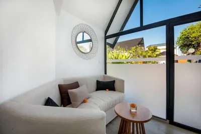 a living room with a couch and a table at Le Cielo Resort Umalas by Maviba in Canggu
