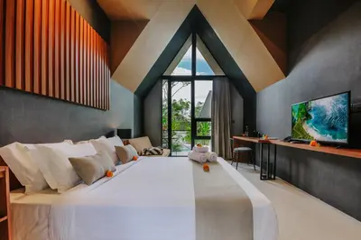 a bedroom with a large bed with a large window at Le Cielo Resort Umalas by Maviba in Canggu