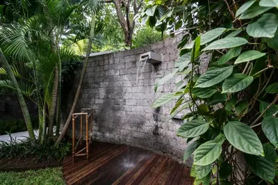 a brick wall with a ladder on a wooden deck at Villa Alopa 1 in Seminyak