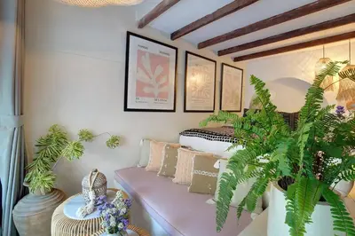 a room with a bed and a bench with plants at Seminyak Beach Bungalow Studio #2 with Private Pool in Seminyak