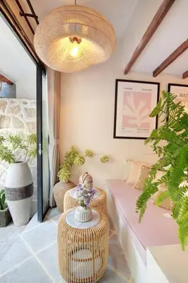 a living room with a couch and a chandelier at Seminyak Beach Bungalow Studio #2 with Private Pool in Seminyak