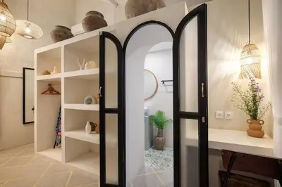 a room with a mirror and a shelf with vases at Seminyak Beach Bungalow Studio #2 with Private Pool in Seminyak
