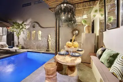 a living room with a pool and a couch and a table at Seminyak Beach Bungalow Studio #2 with Private Pool in Seminyak