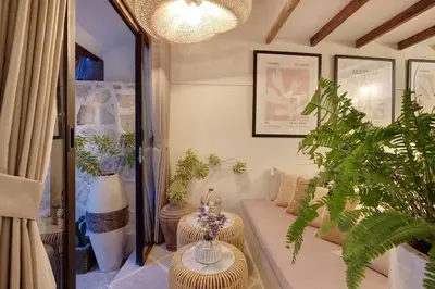 a living room with a couch and some plants at Seminyak Beach Bungalow Studio #2 with Private Pool in Seminyak