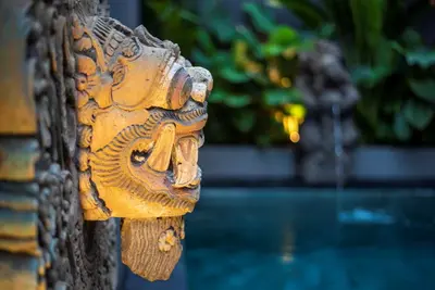 a fire hydrant on the side of a building at Pondok Arya Kuta Villas by Kamara in Kuta