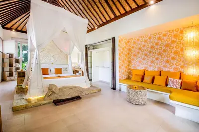 a living room with a couch and a bed at Villa Balissima in Seminyak