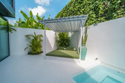 an outdoor patio with a table and a pool at Bali Townhouse 1 - Amazing 2BR Villa w/pool - Perfect Location in Canggu