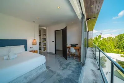 a bedroom with a bed and a desk on a balcony at Bali Townhouse 1 - Amazing 2BR Villa w/pool - Perfect Location in Canggu