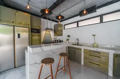 a kitchen with a counter and two stools in it at Bali Townhouse 1 - Amazing 2BR Villa w/pool - Perfect Location in Canggu