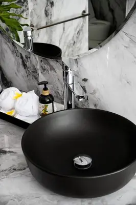 a black sink in a bathroom with a counter at Villa Loba in Seminyak
