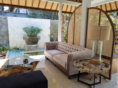 a living room with a couch and a table at Villa Loba in Seminyak