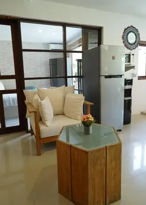a living room with a couch and a refrigerator at Villa Indalia in Seminyak