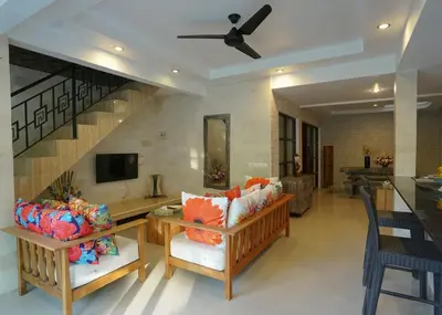 a living room with a couch and a tv at Villa Indalia in Seminyak