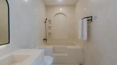 a white bathroom with a tub and a toilet at Seffalas Villa by Betterplace in Canggu