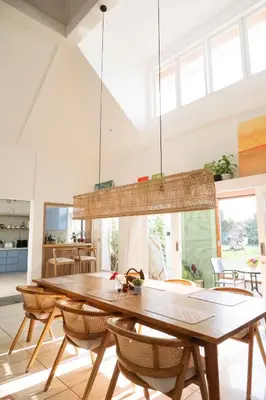 a dining room with a wooden table and chairs at DORALICE by a Paddy Field in Kerobokan