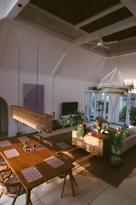 a living room with a table and a couch at DORALICE by a Paddy Field in Kerobokan
