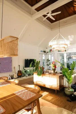 a living room with a table and a couch at DORALICE by a Paddy Field in Kerobokan