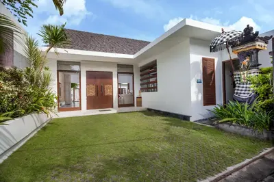 a house with a lawn in front of it at Villa Illam in Seminyak
