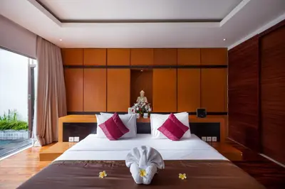 a bedroom with a large bed with towels on it at Villa Illam in Seminyak