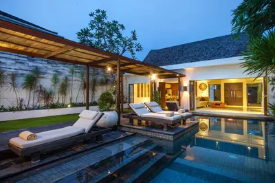 a backyard with a swimming pool and a villa at Villa Illam in Seminyak
