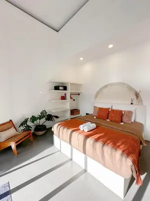 a bedroom with a large bed in a white room at Stella Moon Villa Bali in Kerobokan