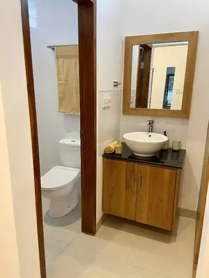 a bathroom with a toilet and a sink and a mirror at Villa Solas Legian in Legian