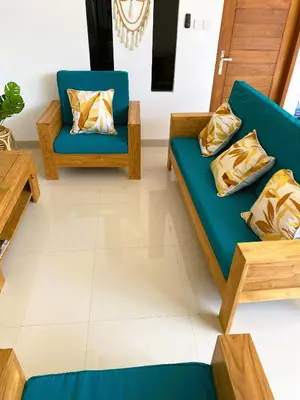 a living room with two chairs and a couch at Villa Solas Legian in Legian