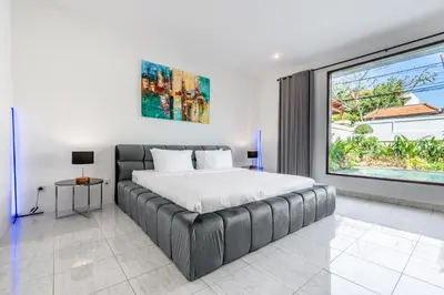 a bedroom with a bed and a large window at Villa Sky View - Seminyak in Seminyak