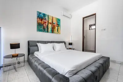 a bedroom with a large bed and a couch at Villa Sky View - Seminyak in Seminyak