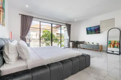 a bedroom with a large bed and a large window at Villa Sky View - Seminyak in Seminyak