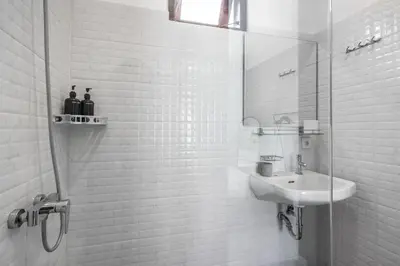 a white bathroom with a sink and a mirror at Villa Sky View - Seminyak in Seminyak