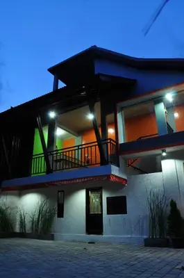 a large house with a balcony on top of it at Amerta Home Stay Bali in Denpasar
