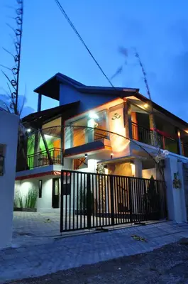 a house with a fence in front of it at Amerta Home Stay Bali in Denpasar