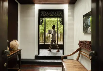 a man walking through a door in a house at Villa Samuan in Seminyak
