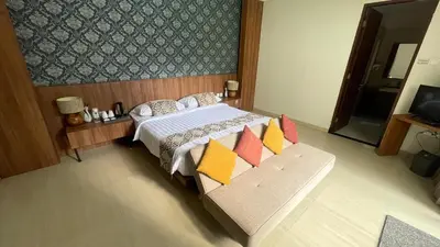 a bedroom with a bed and a couch with pillows at The BALIem Villa in Jimbaran