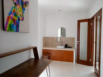 a bathroom with a sink and a counter at De'Huta Villa in Canggu