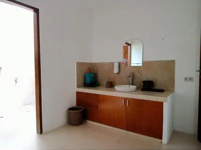 a bathroom with a sink and a mirror at De'Huta Villa in Canggu