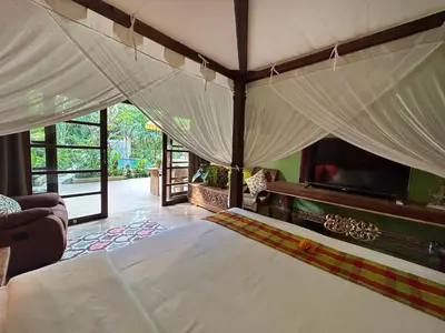 a bedroom with a large bed with a canopy at The Chand Villa - A Hidden Gem in Petitenget in Seminyak