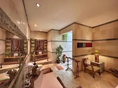 a large living room with a table and a chair at The Chand Villa - A Hidden Gem in Petitenget in Seminyak