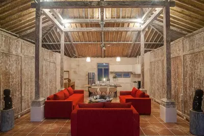 a living room with red couches and a table at Selog Villa 2 in Seminyak