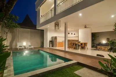a swimming pool in the middle of a house at Selog Villa 4 in Seminyak