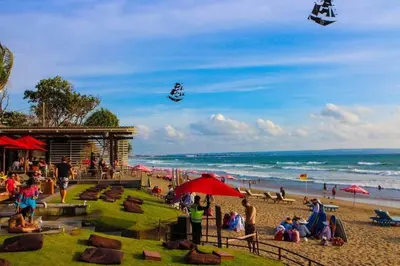 a group of people on a beach with people flying kites at Selog Villa 4 in Seminyak